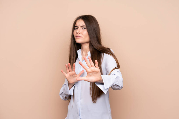 Young woman over isolated background nervous stretching hands to the front - Photo, Image