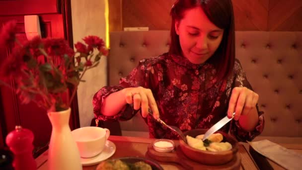 woman eating dumplings in cafe with red light  - Footage, Video