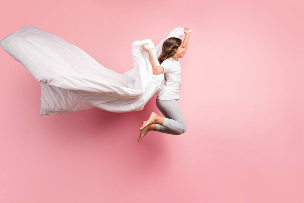 Full length body size view of nice attractive childish playful carefree cheerful cheery wavy-haired pre-teen girl jumping flying with blanket ghost isolated over pink pastel color background - Fotoğraf, Görsel