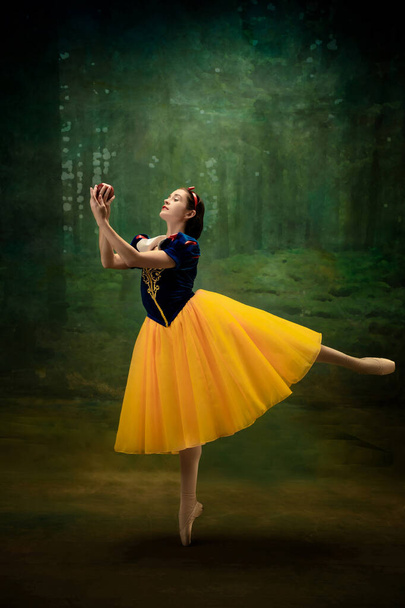 Young ballet dancer as a Snow White with poisoned apple in forest - Foto, Imagem