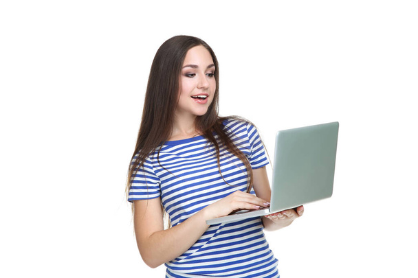 Young girl with laptop computer isolated on white background - Фото, изображение