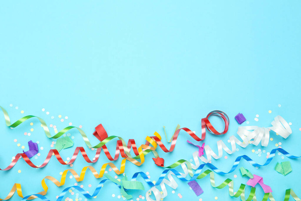 Colorful ribbons with confetti on blue background - Φωτογραφία, εικόνα