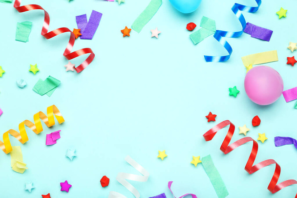Colorful ribbons with rubber balloons and paper stars on blue ba - Foto, imagen