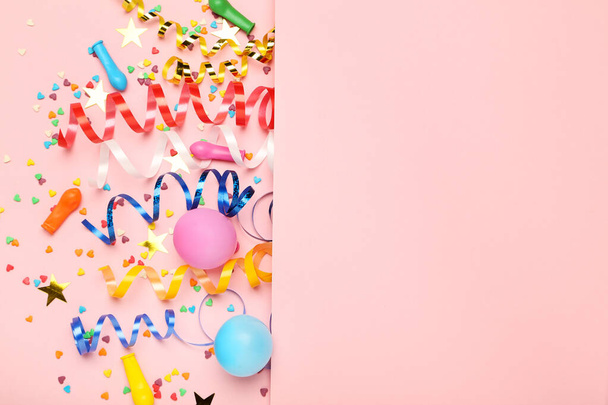 Colorful ribbons with rubber balloons and sprinkles on pink back - Foto, imagen