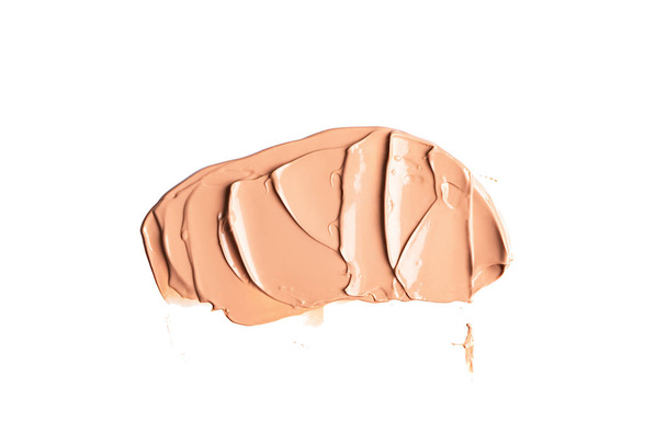 Gently beige smear of makeup creamy foundation isolated on white background. - Φωτογραφία, εικόνα