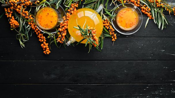 Drink from sea buckthorn berries. Winter hot drink. Fresh sea buckthorn on a twig. Top view. Free space for your text. - Фото, изображение