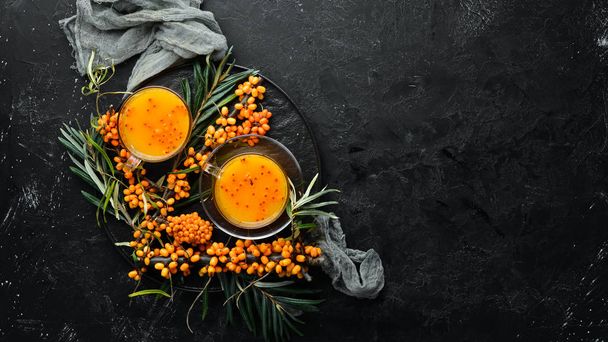 Drink from sea buckthorn berries. Winter hot drink. Fresh sea buckthorn on a twig. Top view. Free space for your text. - Fotoğraf, Görsel
