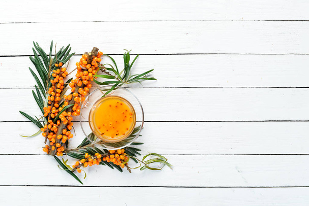 Sea buckthorn tea. Winter hot drink. Top view. Free space for your text. - Foto, Bild