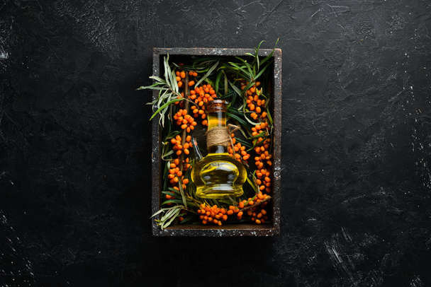 Sea buckthorn oil. Fresh sea buckthorn berries on a twig. Top view. Free space for your text. - Fotoğraf, Görsel