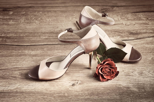 Argentine tango shoes with a rose on wooden floor - Fotoğraf, Görsel