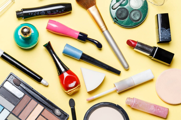 Photo on top of different cosmetics on yellow background - Foto, Imagem