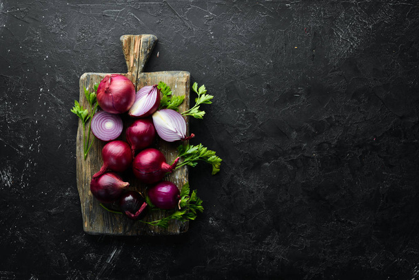 Purple fresh onion on white wooden background. Top view. Free copy space. - 写真・画像