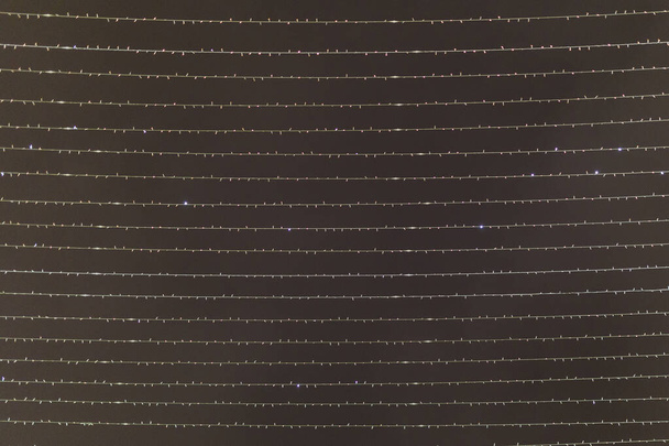 Photo of horizontally arranged garlands on gray background - 写真・画像