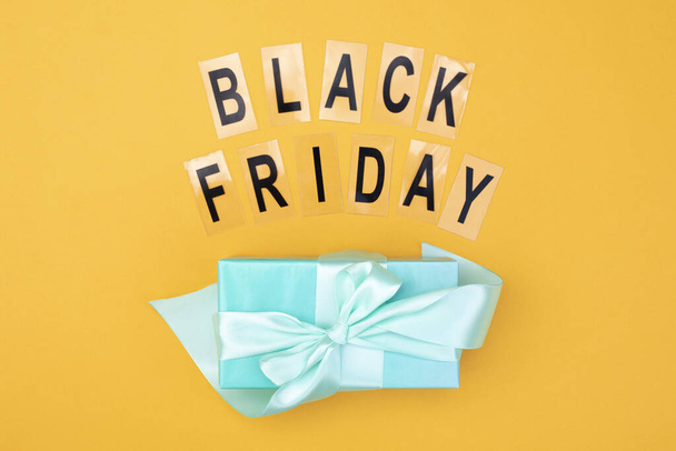 The inscription black friday and a gift with a bow mint color. - Фото, изображение