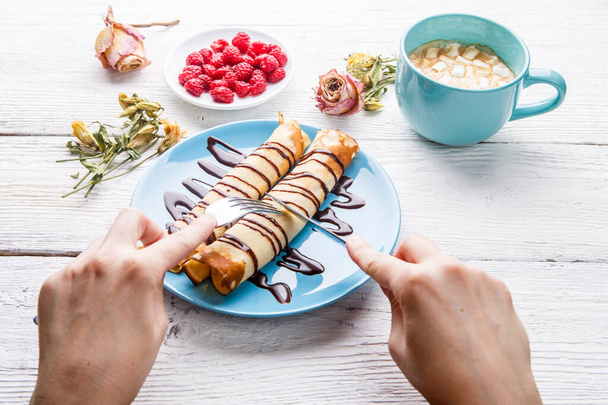 Desayuno de humanos con tortitas, jarabe de chocolate, frambuesas, cacao y malvaviscos
 - Foto, Imagen