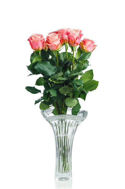 pink roses bouquet in crystal vase, isolated on white - 写真・画像