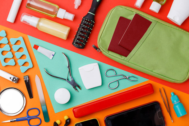 Photo of manicure accessories, comb, phone, beautician on orange background - Фото, изображение