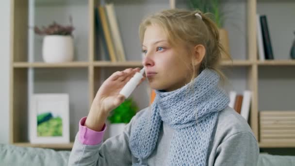A woman with fever and runny nose uses nasal spray at home - Video, Çekim