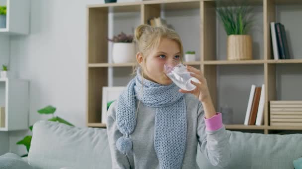 Sick ill woman drinks dissolving effervescent aspirin pill into glass with water - Felvétel, videó