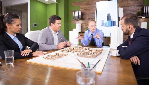 Middle age real estate developer in a meeting with construction engineers - 写真・画像