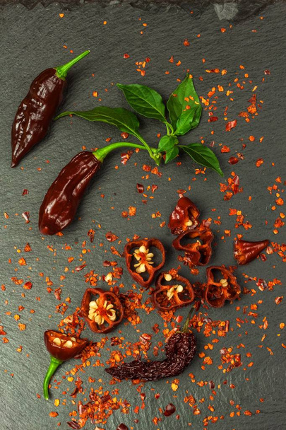 Fresh chilli peppers. Preparation of spicy food. Healthy spices. Extra hot chili pepper ( Capsicum Chinenses ) Bhut Jolokia  Chocolate - Fotó, kép