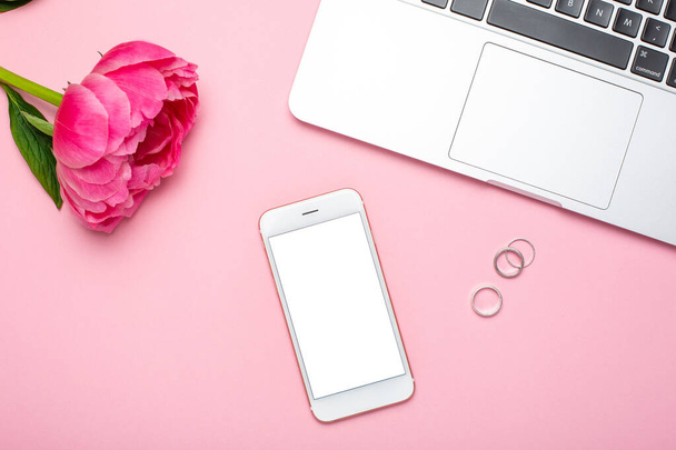Mobile phone mock up and peony flower on pink pastel table in flat lay style. Woman working desk.Summer colour - Photo, Image