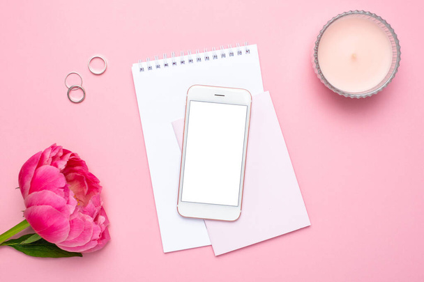 Mobile phone mock up, notebook and peony flower on pink pastel table in flat lay style. Woman working desk.Summer colour - Fotografie, Obrázek