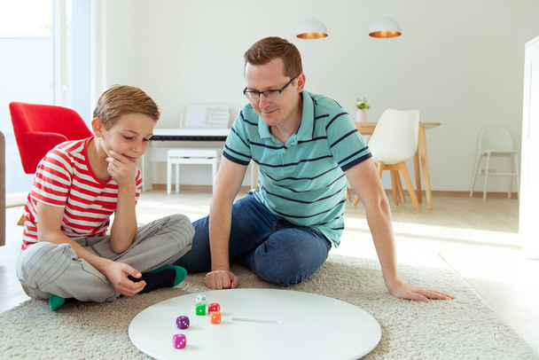 Happy young father plays with his teenager son Board Game with c - Valokuva, kuva