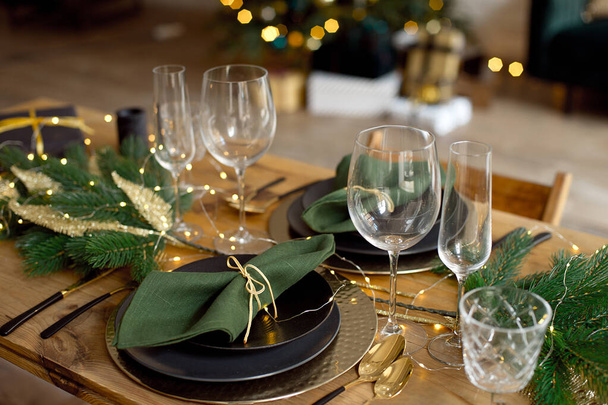 Table served for Christmas dinner in living room, close-up view, table setting, Christmas decoration - Фото, изображение