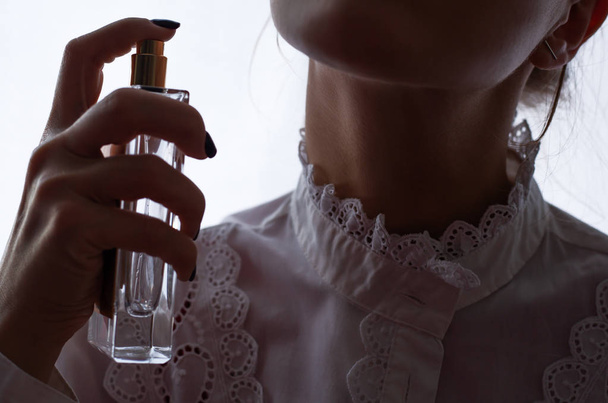 Girl use perfume with amazing fragrance. - Foto, Imagen