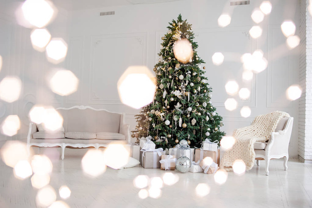 Classic christmas New Year decorated interior room New year tree. Christmas tree with gold decorations. Modern white classical style interior design - Photo, Image