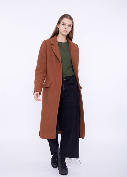 Beautiful fashion model in long brown coat isolated on white background - Valokuva, kuva