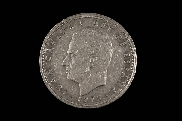 An old Spanish fifty peseta coin featuring Rey Juan Carlos, shot close up in macro, on a black background - Photo, Image