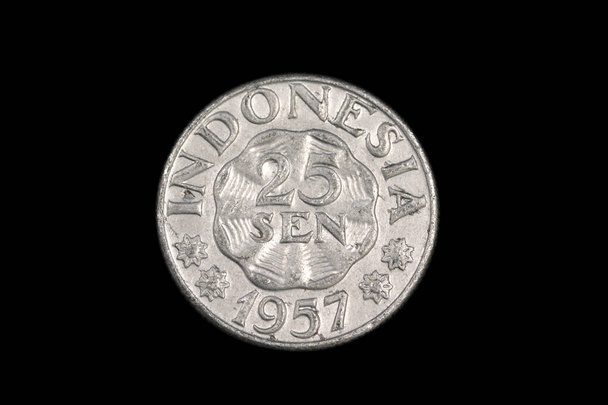 An old Indonesian, twenty five sen coin from 1957, shot close up in macro against a black background - Photo, Image