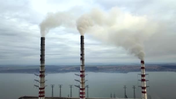 Zicht vanuit de lucht op hoge schoorsteenpijpen met grijze rook van kolencentrales. Productie van elektriciteit met fossiele brandstoffen. - Video