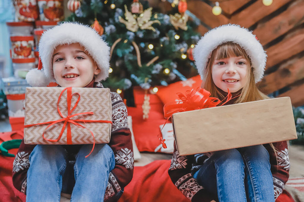 Close up photo of son and daughter preparing Xmas gifts for their parents. - Zdjęcie, obraz