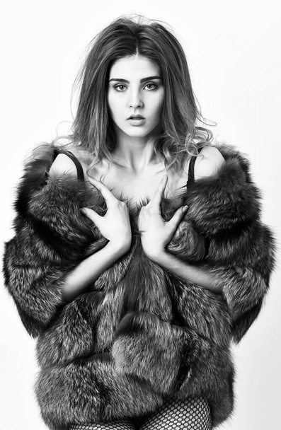 Elite clothes for sensual girl. Fashion luxury design. Girl temptress wear stockings and fur coat. Woman tousled hairstyle posing lingerie and fur jacket. Fashion boutique concept. Fashion for female - 写真・画像