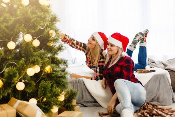 sisters posing in decorated room with christmas items  - Photo, Image