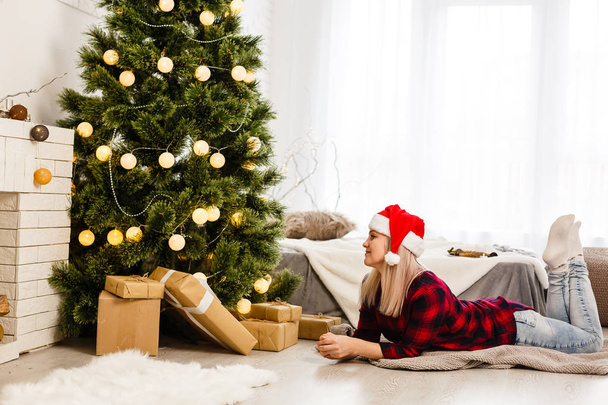 Beautiful Woman at Christmas time at home - 写真・画像