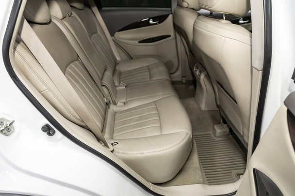 Novosibirsk, Russia  September 18, 2019:  Infiniti EX, close-up of the beige leather  rear seats with seats belt. modern car interior - 写真・画像