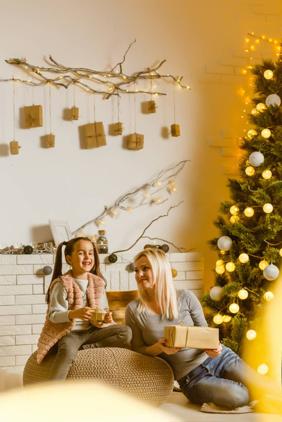 Mother and daughter spending time together at home in Christmas - Photo, Image
