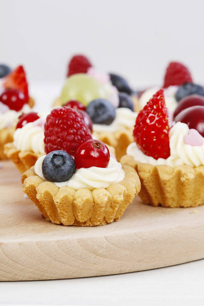 Colorful cupcakes with fresh fruits.  - Photo, image