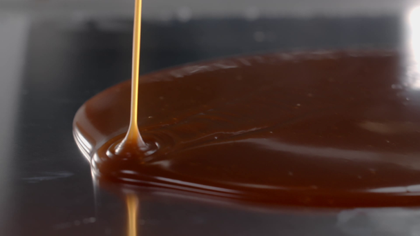 Salty melted caramel is poured to the metal surface in the kitchen, making of the candies, cooking dessert in slow motion, confectionery, sweet-shop, Full HD 240fps Prores 422 HQ 10 bit - Footage, Video