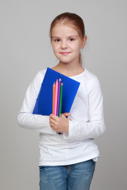 Girl holding a blue folder and pencils - Φωτογραφία, εικόνα