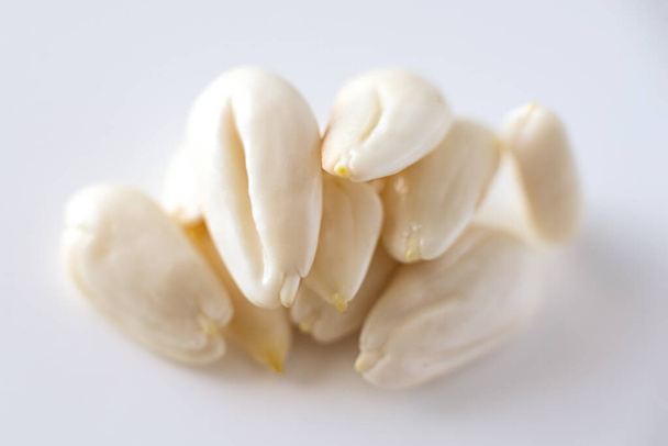 row, line of peeled young almonds on a white background, isolate, nut antioxidant - Photo, Image