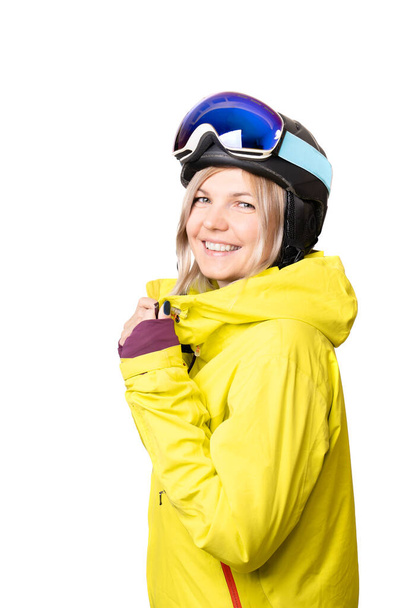 Portrait of a young woman dressed in yellow snowboard jacket, black helmet and glasses isolated on white background - Zdjęcie, obraz