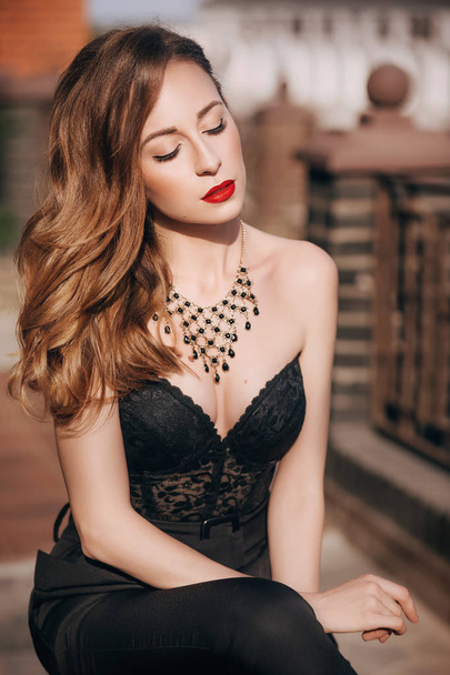 portrait of a beautiful young woman in black corset - Фото, зображення