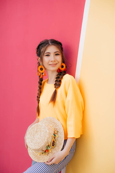 beautiful young woman with two braids and straw hat  - Foto, afbeelding
