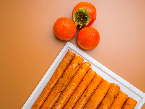delicious dried mashed fruit pulp from apricot, persimmon. Georgian and Armenian cuisine. Fruit pastille from orange fruit and persimmon. - Foto, Imagem