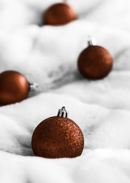 Chocolate brown Christmas baubles on white fluffy fur backdrop,  - Photo, Image